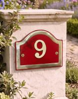 A Number 9 Arched House Number Sign in a Claret & Brass Finish Mounted on a Stone Garden Driveway pillar - Digital Illustration 