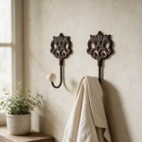 A Pair of "Lady Elinor" Cast Iron Hooks Mounted on a Wall in a Traditional Home - Digital Illustration A Pair of "Lady Elinor" Cast Iron Hooks Mounted on a Wall in a Traditional Home - Digital Illustration