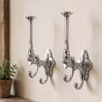 A Pair of Bright Chrome Art Deco Styled 3 Prong Hat and Coat Hooks in a Sunny Home Hallway - Digital Illustration 