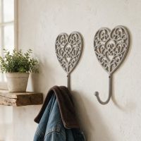 A Pair of “Heartford” Scroll Heart Design Hook  next to a Shelf in a Decorative Home - Digital Illustration 