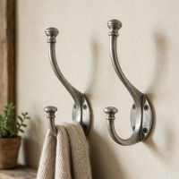 A Pair of Pewter Wall Mounted Coat Hooks Mounted Next to a Shelf on an Interior Wall - Digital Illustration 