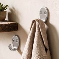 A Pair of Satin Chrome Single Pronged Coat Hook on a Hallway Wall next to a Timber Shelf - Digital Illustration 