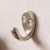 A Polished Nickel Single Pronged Coat Hook Attached to a Textured Home Wall - Digital Illustration A Polished Nickel Single Pronged Coat Hook Attached to a Textured Home Wall - Digital Illustration