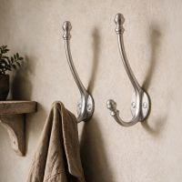 A Pair of Satin Chrome Double Pronged Mushroom-Capped Coat Hooks in the Hallway of a Country Home - Digital Illustration A Pair of Satin Chrome Double Pronged Mushroom-Capped Coat Hooks in the Hallway of a Country Home - Digital Illustration