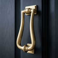 A Satin Brass Art-Deco Style Door Knocker on a Front Door to a Period Home - Digital Illustration
