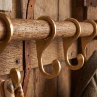 A Set of Round Clothes Rail Hook on a Wooden Rail in a Country Home - Digital Illustration 