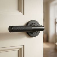 A White Door with a "Bray Manor" Matte Black Textured Unsprung Lever Door Handle on Rose Mounted on it in a Country Home - Digital Illustration