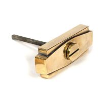 Close-Up of Aged Brass Art Deco Bathroom Thumb Lock in Situ