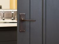 Aged Bronze Lever Latch Door Handle on Door