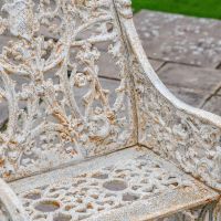 Close up of Aged Cream Cast Iron Bench Detailing