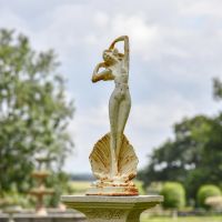Lady Standing on Clam Sculpture in Situ in the Garden