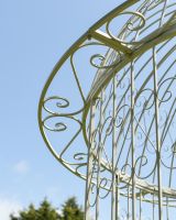 Close up of iron scrollwork detail on garden gazebo