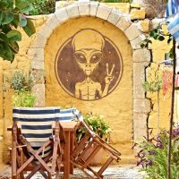 Peace Sign Alien Wall Art in Situ on a Yellow Wall Peace Sign Alien Wall Art in Situ on a Yellow Wall