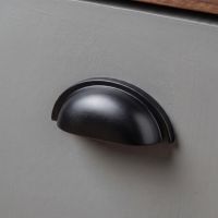 An Art Deco Concealed Cup Drawer Pull in Aged Bronze Shown Close up as Part of a Kitchen Renovation Project for a Set of Drawers - Digital Illustration