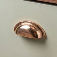 An Art Deco Concealed Cup Drawer Pull in Polished Bronze on an Olive Green Kitchen Drawer in a Contemporary Home - Digital Illustration An Art Deco Concealed Cup Drawer Pull in Polished Bronze on an Olive Green Kitchen Drawer in a Contemporary Home - Digital Illustration