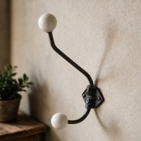 An Off White Ceramic Tip Large Iron Coat Hook Attached to a Cream Coloured wall in an Entrance Hallway - Digital Illustration An Off White Ceramic Tip Large Iron Coat Hook Attached to a Cream Coloured wall in an Entrance Hallway - Digital Illustration
