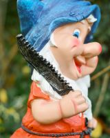 Close up of saw detail on colourful outdoor gnome sculpture