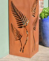 Close up of cut our fern detail on rustic garden column