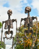 Close up of intricate detail on skeletond holding hands garden sculpture