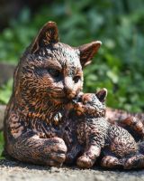 Close up of intricate detail on brushed bronze mother and child cat and kitten statue