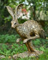 Angled view of gold hare garden statue