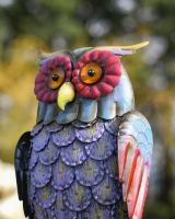 Close up of face detail on colourful steel garden ornament