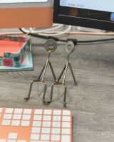 Angled view of scrap metal phone holder sculpture