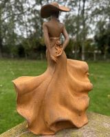 Close up of intricate rose detail on dancing lady garden sculpture