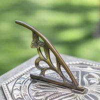 Close-Up of Ornate Gnomon on Antique Brass Sundial Close-Up of Ornate Gnomon on Antique Brass Sundial