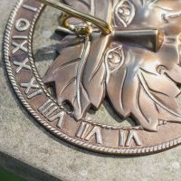 Close-Up of Antique Brass Sundial with Cast Shadow