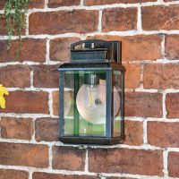 Antique Bronze Hanging Wall Light With Reflector Plate in Situ on a Brick Wall Antique Bronze Hanging Wall Light With Reflector Plate in Situ on a Brick Wall