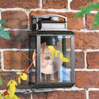 Antique Bronze Hanging Wall Light With Reflector Plate in Use Outdoors Antique Bronze Hanging Wall Light With Reflector Plate in Use Outdoors