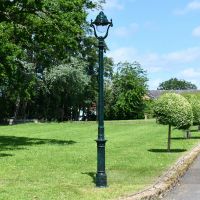 Antique Green Opulent Cast Iron Lamp Post In Garden Setting