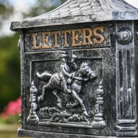 Close-Up of Golden Lettering on Freestanding Post Box