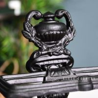 Close-up of the Ornate Urn Design at the Top of the Umbrella Stand