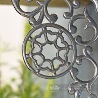 Close up of casting on bright chrome shelf bracket Close up of casting on bright chrome shelf bracket