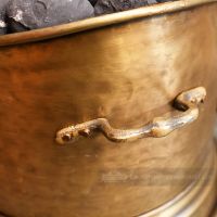 Close up of support handle on Antique Bronze coal Scuttle Close up of support handle on Antique Bronze coal Scuttle