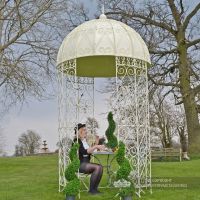 Ornate tradtional gazebo in garden with solid roof Ornate tradtional gazebo in garden with solid roof