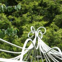 Ornate scrolled finial on top of roof on gazebo