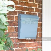 Light pastel blue post box by front door
