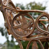 Close up of Rustic Cast Iron embellishments on single seater bench