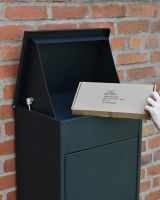 Bexley wall-mounted parcel box in Black top open with parcel