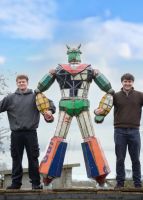 "Sentry" the Robot Upcycled Oil Drum Garden Sculpture to scale with two men either side locking arms