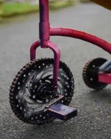 ‘Freewheeler” the Upcycled Metal Giraffe Garden Sculpture on a Tricycle close up of front wheel made from gears and chains