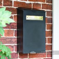 Black and Brass Newspaper Box On Brick Wall Black and Brass Newspaper Box On Brick Wall