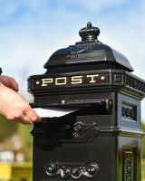 Black Post Box With Letter Being Posted  Black Post Box With Letter Being Posted