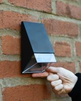 Black angled wall light to scale