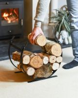 Scale Shot Of Black Blacksmith Curved Log Rack Scale Shot Of Black Blacksmith Curved Log Rack