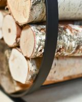 Close Up Of Black Blacksmith Curved Log Rack In Situ Close Up Of Black Blacksmith Curved Log Rack In Situ