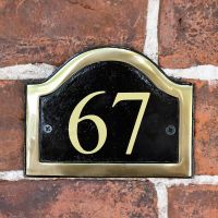 The Number 67 in Vinyl on the Arched Black & Brass Number Plaque